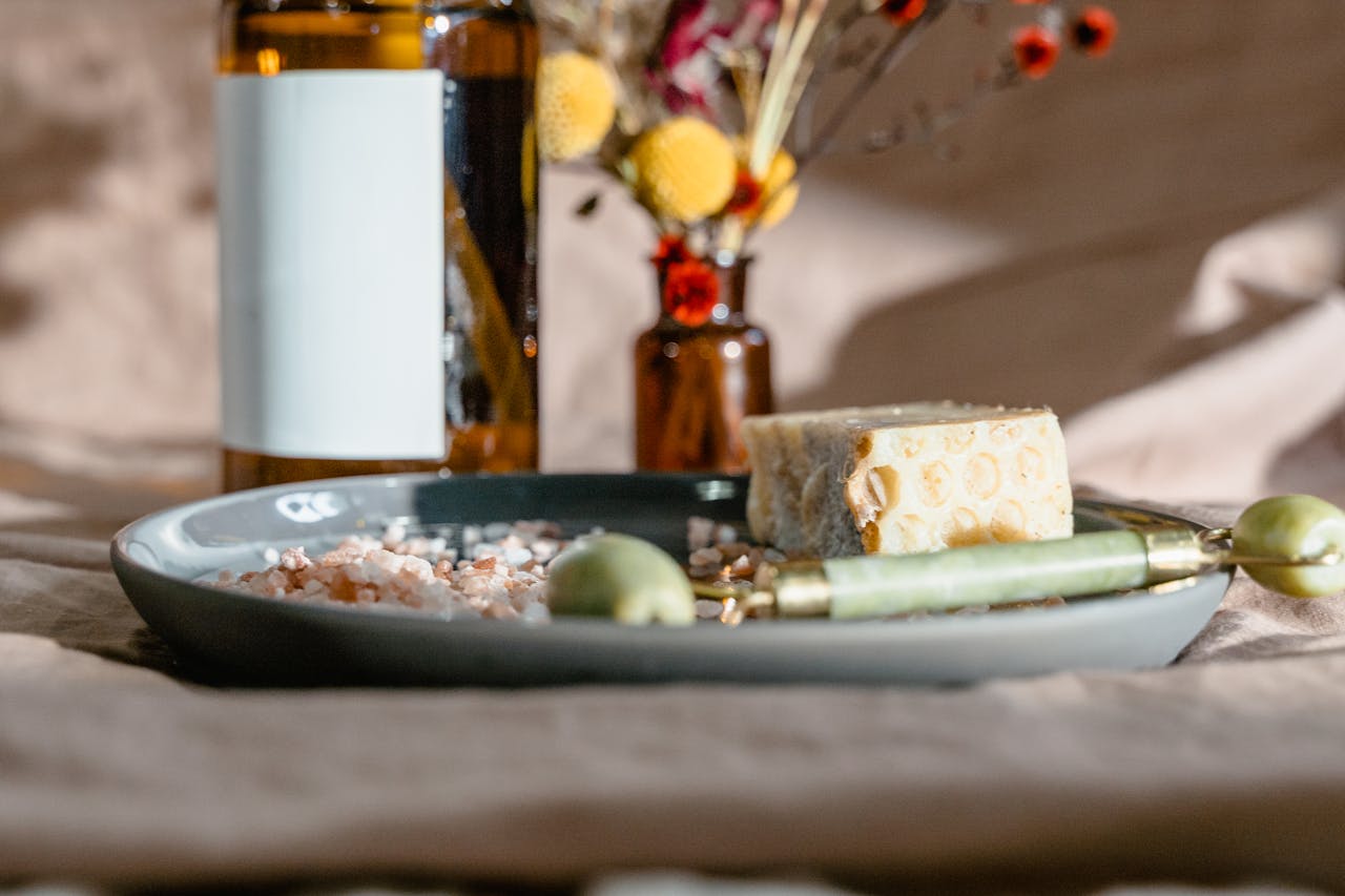 Elevate your self-care routine with this calming arrangement of spa essentials, including a jade roller and natural soap.
